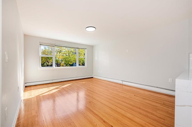 spare room featuring light hardwood / wood-style flooring and baseboard heating