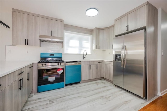 kitchen with light brown cabinets, stainless steel appliances, tasteful backsplash, and sink