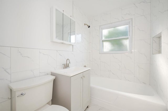 full bathroom with vanity, toilet, and tiled shower / bath