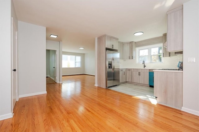 kitchen featuring sink, stainless steel appliances, and light hardwood / wood-style flooring