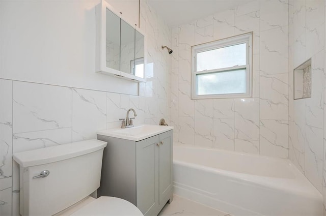 full bathroom with vanity, tiled shower / bath combo, toilet, and tile walls