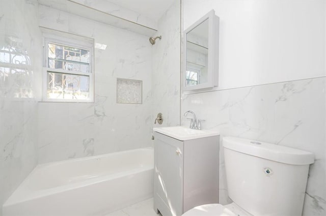 full bathroom with vanity, toilet, tile walls, and tiled shower / bath combo