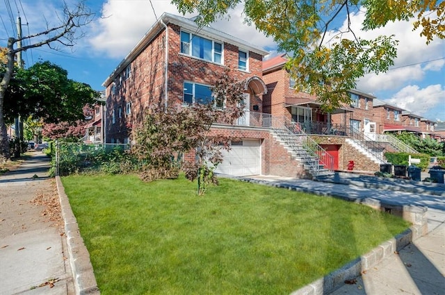 view of front of property featuring a front yard and a garage