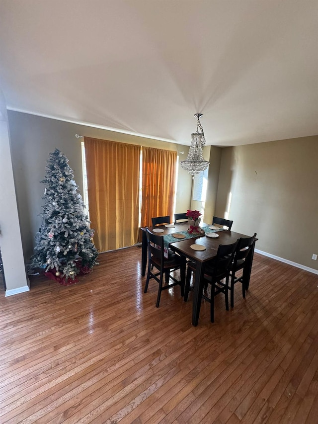 dining room featuring a notable chandelier and hardwood / wood-style flooring