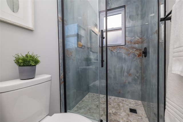 bathroom with toilet and an enclosed shower