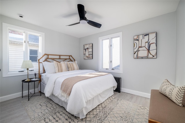 bedroom with ceiling fan and light hardwood / wood-style floors