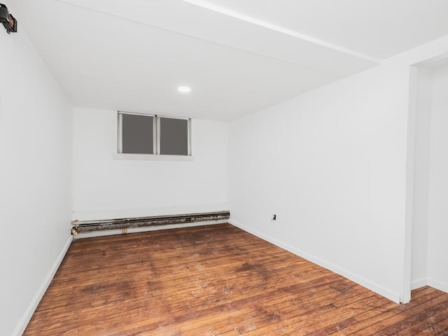 spare room featuring hardwood / wood-style floors and baseboard heating