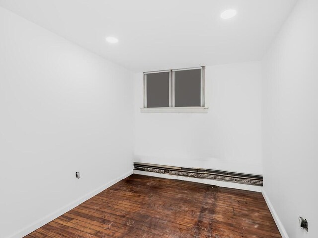 empty room with dark hardwood / wood-style floors