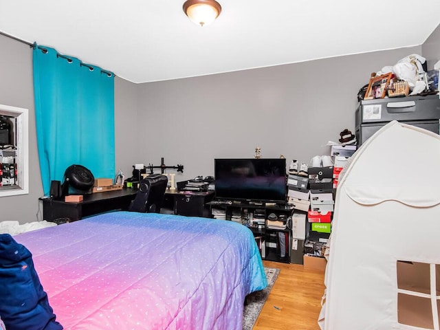 bedroom with hardwood / wood-style flooring