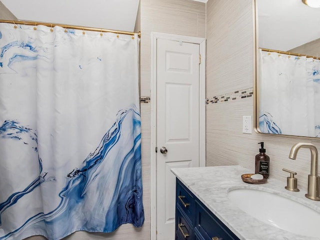 bathroom with vanity and tasteful backsplash