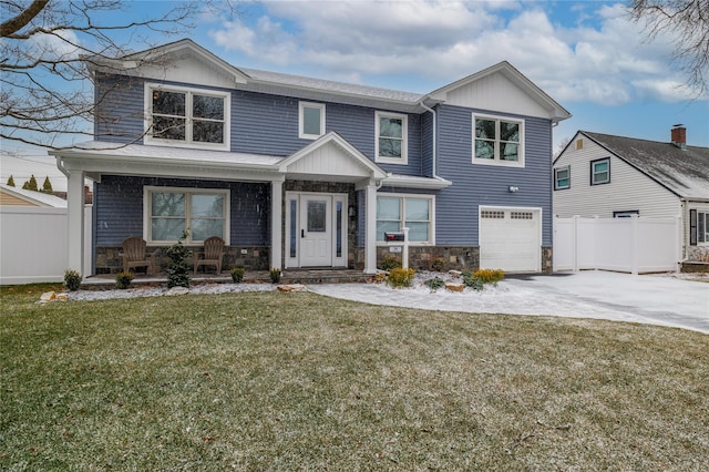 view of front facade featuring a front lawn, a porch, and a garage