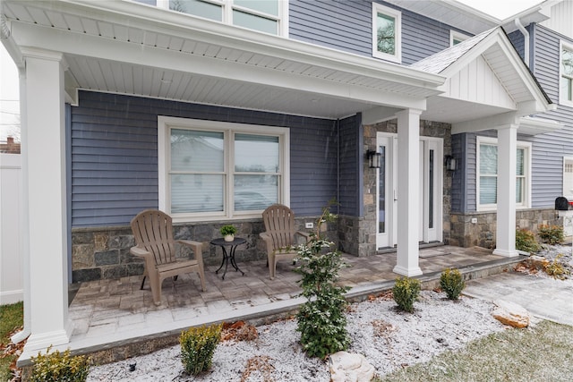 view of exterior entry with a porch