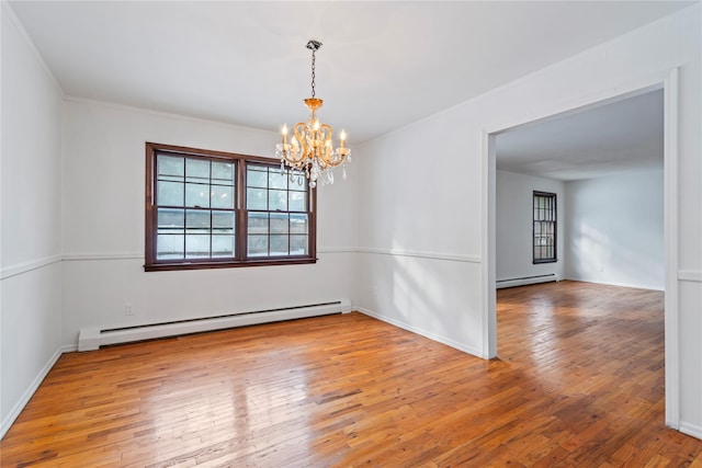 empty room featuring hardwood / wood-style flooring, a baseboard radiator, and a chandelier