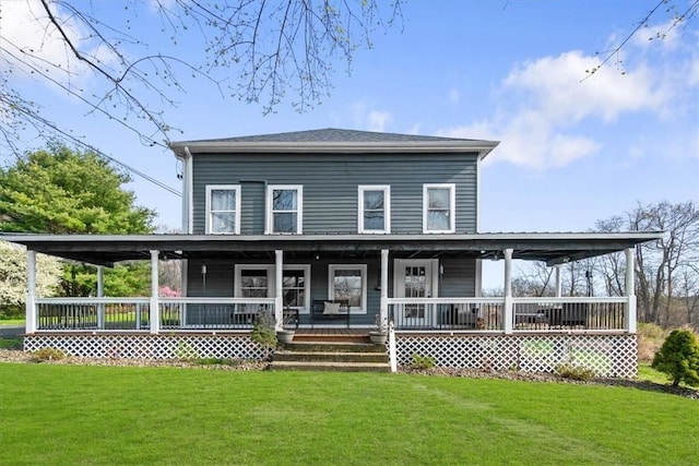 back of property with a yard and a porch