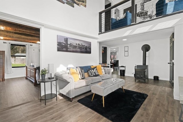 living room featuring a wood stove and hardwood / wood-style flooring