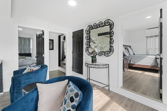 interior space featuring hardwood / wood-style floors and a wall unit AC