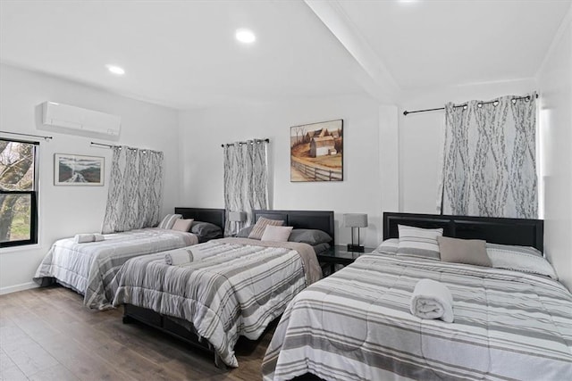 bedroom with a wall mounted air conditioner and wood-type flooring