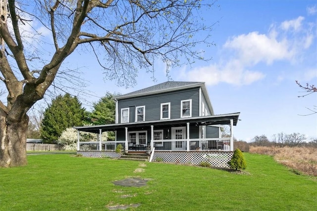 rear view of property with a lawn and a porch