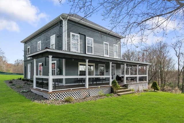 back of house featuring a porch and a yard