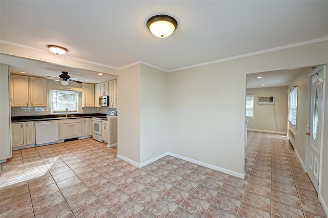 kitchen with sink, white appliances, crown molding, and tasteful backsplash