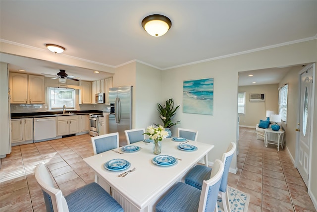 tiled dining space with an AC wall unit, sink, and ornamental molding