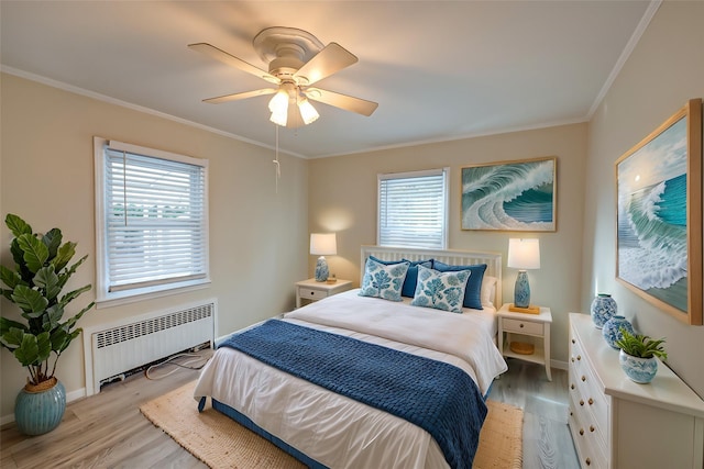 bedroom with ceiling fan, multiple windows, radiator, and crown molding