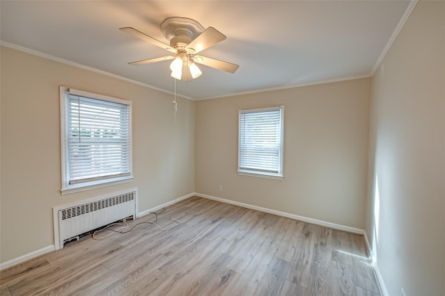 empty room featuring crown molding, light hardwood / wood-style floors, radiator, and ceiling fan