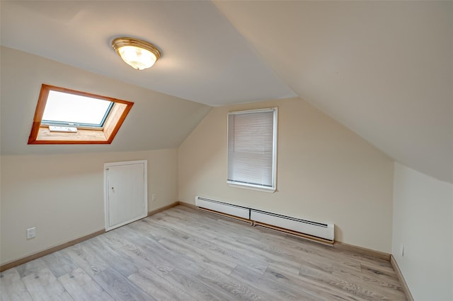 bonus room with lofted ceiling with skylight, light hardwood / wood-style flooring, and a baseboard radiator