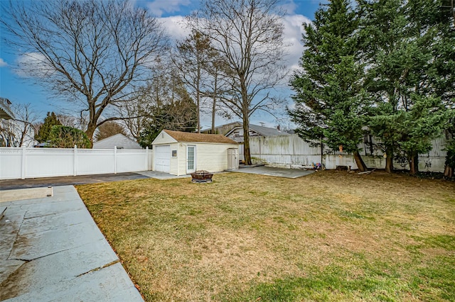 view of yard featuring an outdoor fire pit, an outdoor structure, and a patio