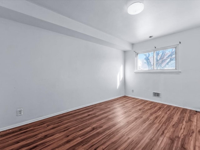 spare room featuring wood-type flooring