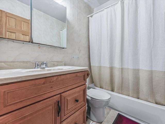 full bathroom with tasteful backsplash, tile walls, toilet, vanity, and shower / tub combo