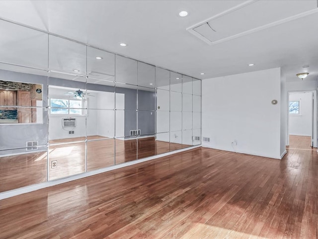 unfurnished living room featuring ceiling fan and wood-type flooring