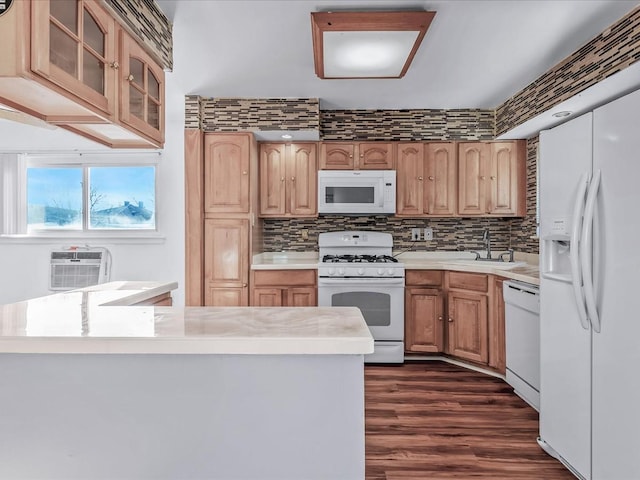 kitchen with a wall mounted air conditioner, white appliances, dark wood-type flooring, sink, and tasteful backsplash