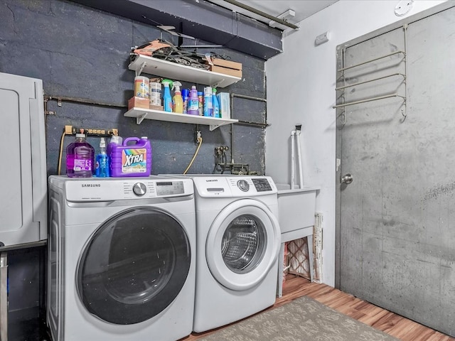 washroom with independent washer and dryer and hardwood / wood-style flooring