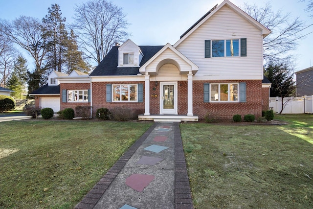 view of front of house featuring a front yard and a garage