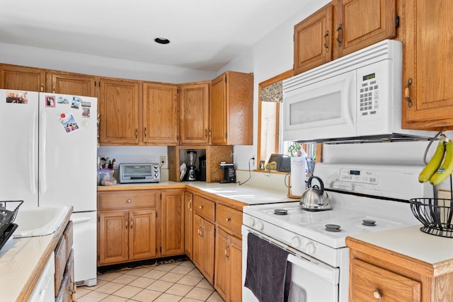 kitchen featuring white appliances and light tile patterned floors