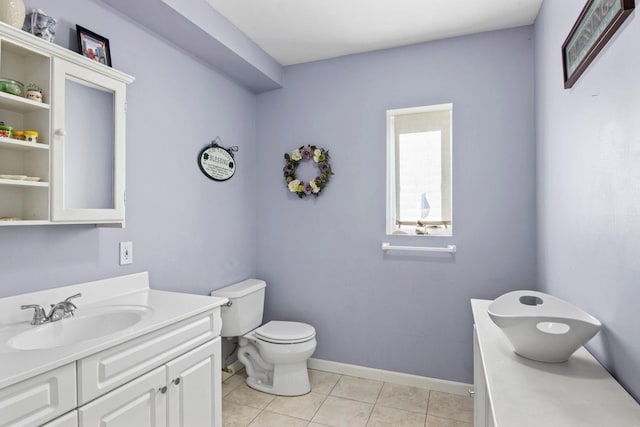 bathroom featuring tile patterned flooring, vanity, and toilet