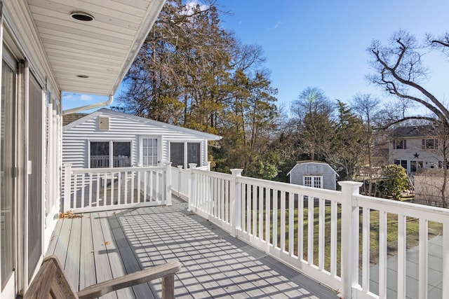 wooden terrace featuring a shed