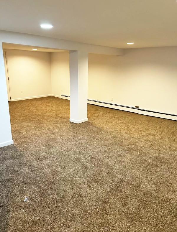 82 Ketewamoke Ave, Babylon, NY 11702 - finished basement featuring carpet flooring, recessed lighting, and a baseboard radiator
