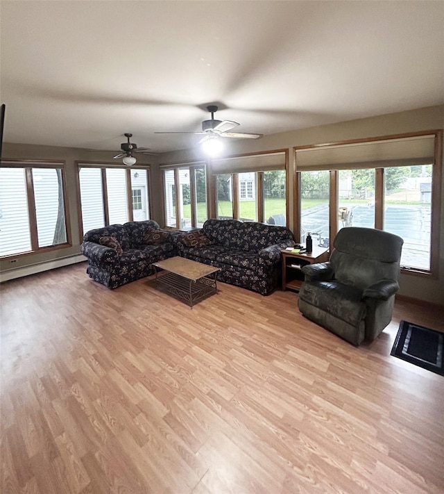 82 Ketewamoke Ave, Babylon, NY 11702 - living area featuring light wood finished floors, a baseboard heating unit, plenty of natural light, and ceiling fan