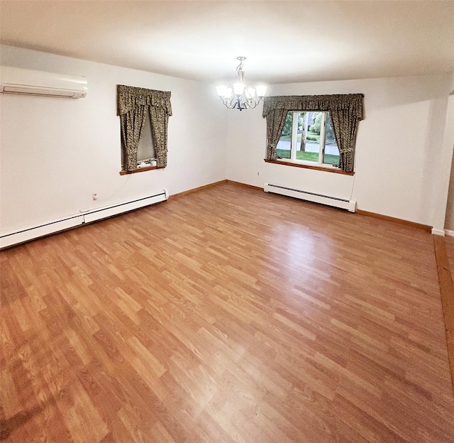 82 Ketewamoke Ave, Babylon, NY 11702 - unfurnished room with a baseboard heating unit, a wall unit AC, wood finished floors, and a chandelier