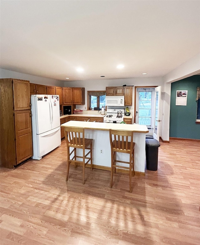 82 Ketewamoke Ave, Babylon, NY 11702 - kitchen with white appliances, light countertops, light wood-type flooring, brown cabinetry, and recessed lighting
