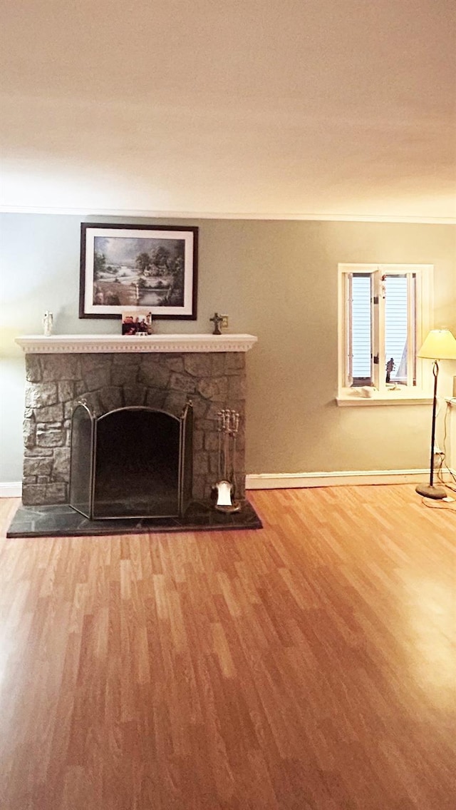 82 Ketewamoke Ave, Babylon, NY 11702 - unfurnished living room featuring a stone fireplace and wood finished floors