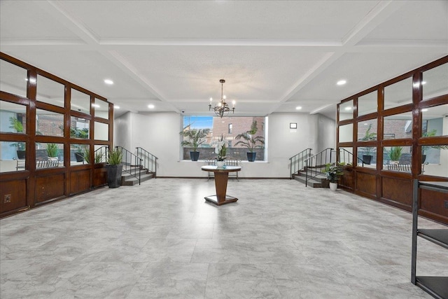 interior space featuring beamed ceiling, a chandelier, and coffered ceiling