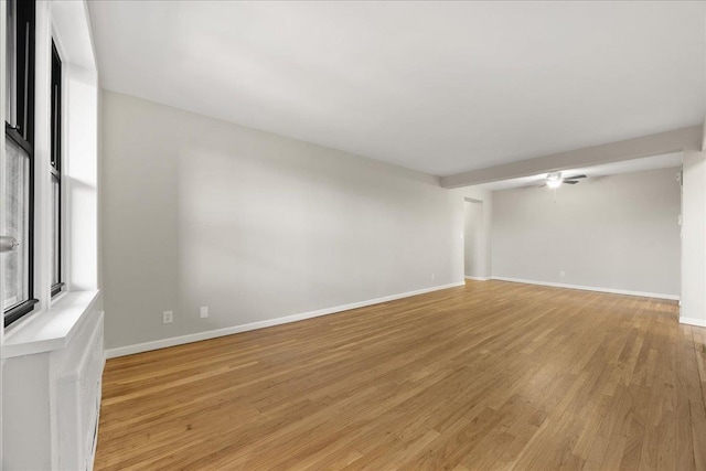 unfurnished room with ceiling fan and light wood-type flooring