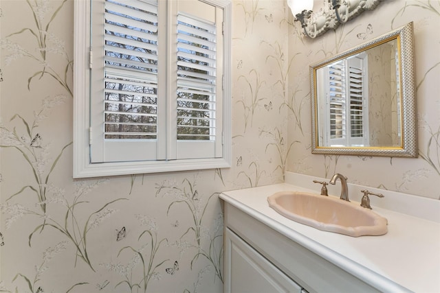 bathroom featuring vanity and wallpapered walls