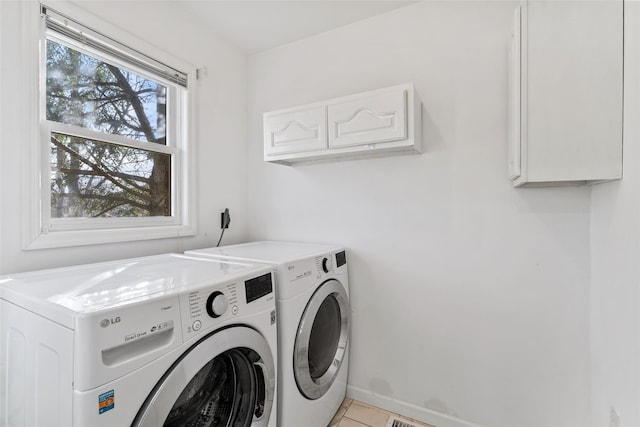 laundry room featuring cabinet space, baseboards, and separate washer and dryer