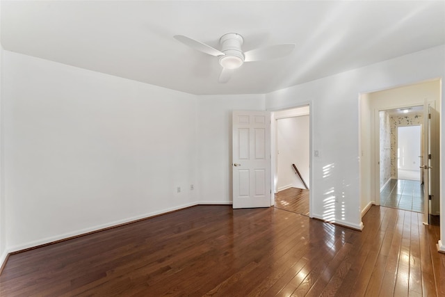 unfurnished bedroom with baseboards, dark wood finished floors, and a ceiling fan