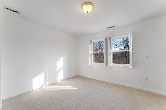 carpeted empty room with baseboards and visible vents