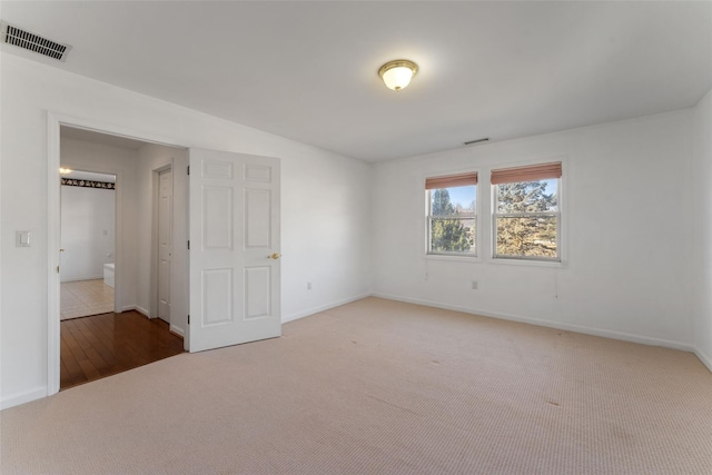 unfurnished bedroom featuring visible vents, carpet flooring, and baseboards